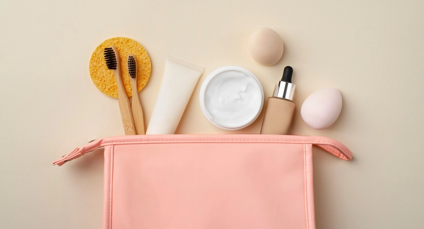 Top view pink toilet bag and products